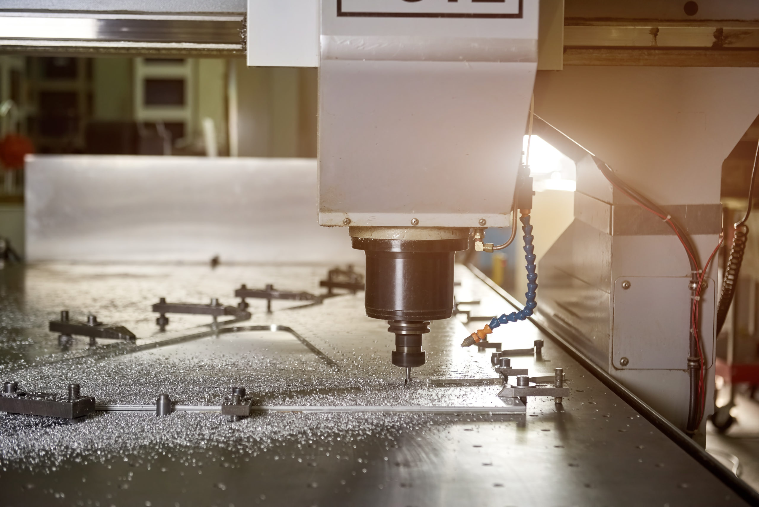 Closeup on precision cnc machine drilling metal in a large workshop
Author: New Way Air Bearings