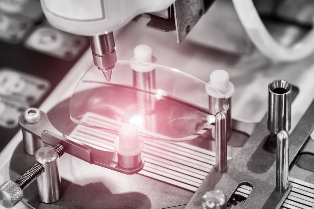 An eyeglass lens being manufactured.