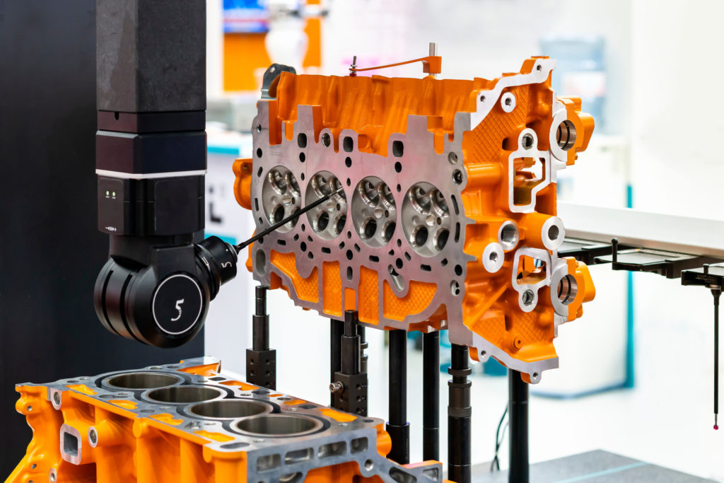 Coordinate measuring machine inspects an engine block.