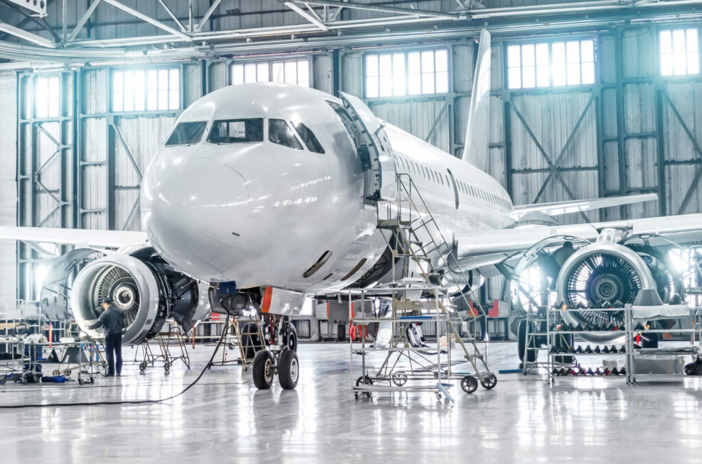Aircraft undergoing maintenance in a hanger