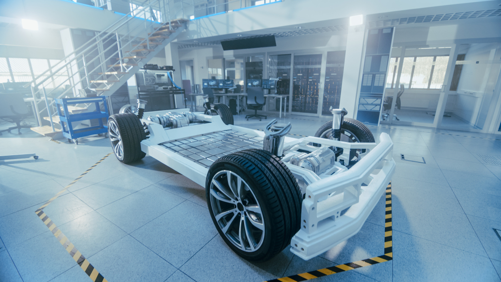 EV chassis with exposed battery pack in manufacturing facility