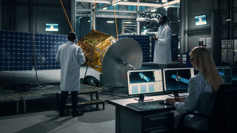 Engineers working on a satellite